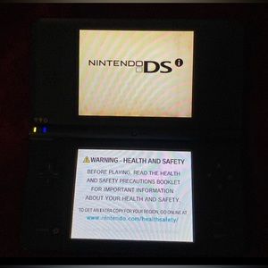 This is a Nintendo DSi XL that comes with games, a game carrier, and a charger.